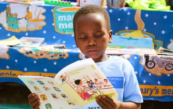 A child reads a book at school