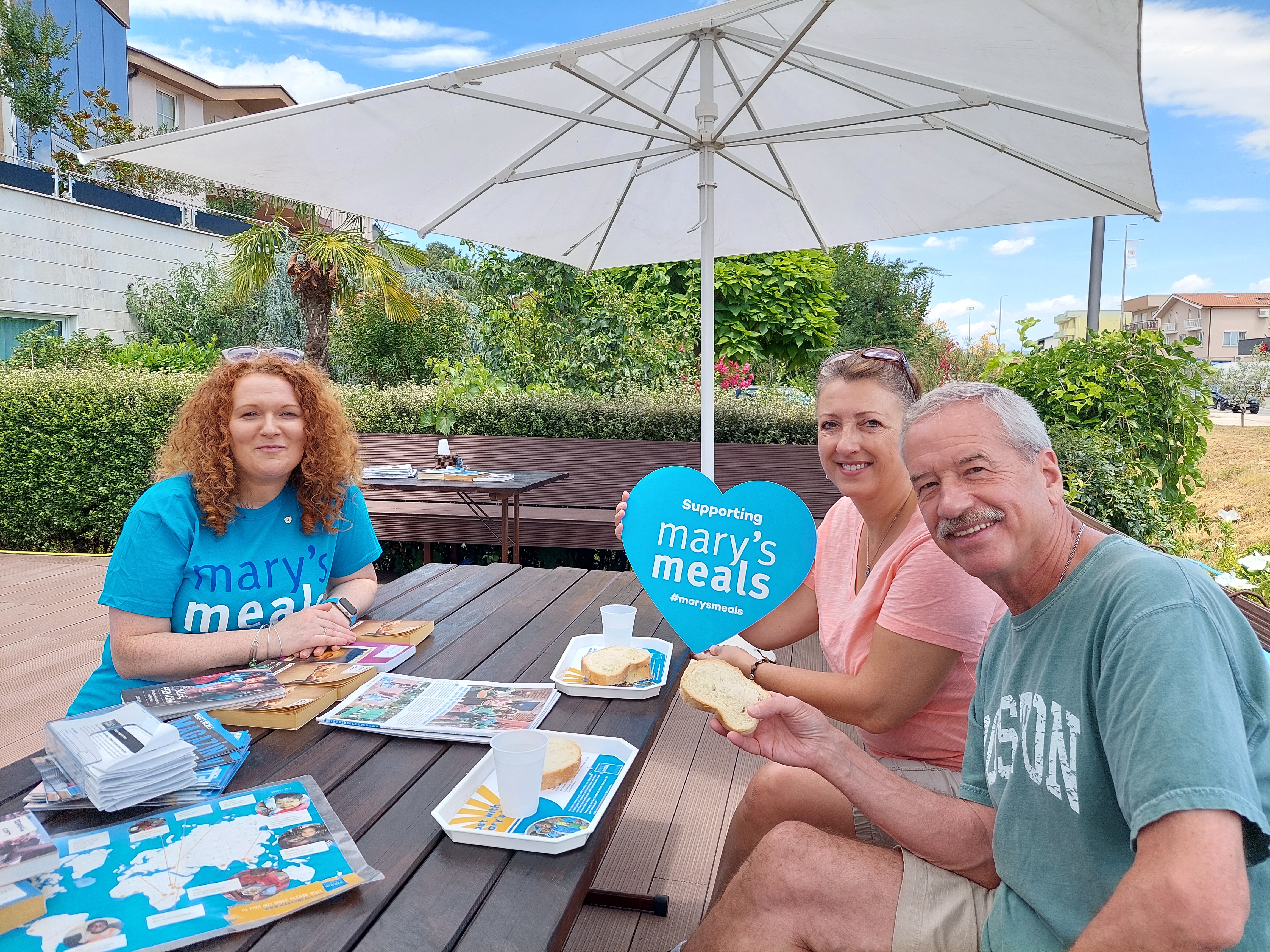 group of people sitting at a table outdoors