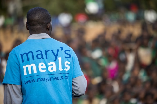 close up of the back of a man wearing a Mary's Meals t-shirt
