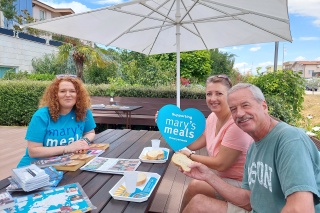 group of people sitting at a table outdoors