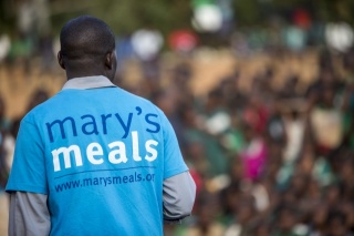 close up of the back of a man wearing a Mary's Meals t-shirt