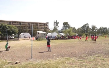 Children and young men playing football in Ethiopia