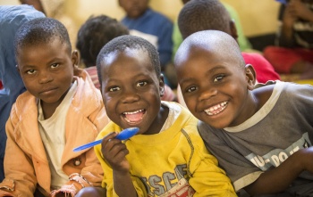 young children smiling at camera