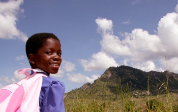 A young girl makes her way to school