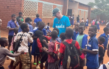 Arthur Coary meeting school children.