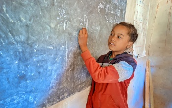 A child takes notes in class