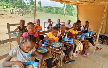 Children eating Mary's Meals in school in Liberia