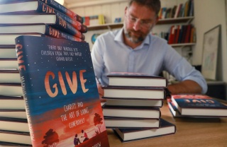 Magnus MacFarlane-Barrow, founder of Mary's Meals signing copies of his book, GIVE. 