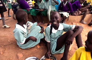 A girl laughs with her friends in South Sudan
