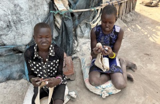 two girls kneeling on the ground