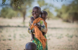 A child carries his sibling