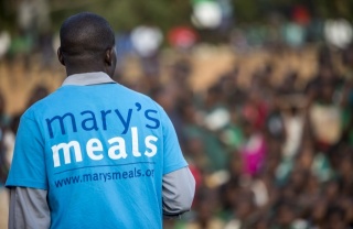 close up of the back of a man wearing a Mary's Meals t-shirt
