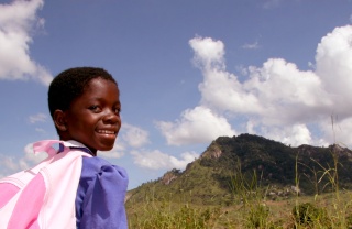 A young girl makes her way to school