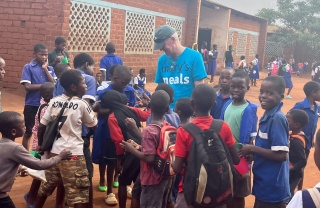 Arthur Coary meeting school children.