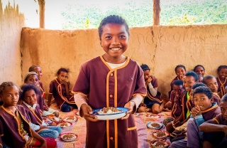 a child with a bowl of food