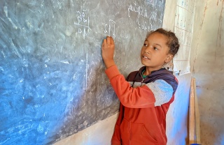 A child takes notes in class