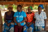 group of people sitting in a line chatting