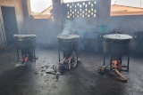 Image of3  cooking pots sitting on stoves as school meals are prepared.