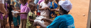 Children being served food in Benin