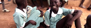 A girl laughs with her friends in South Sudan