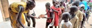 long line of children queuing up for food