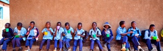 Children sit outside their school in Zambia