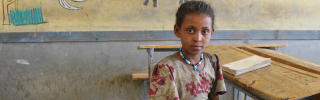 Picture of Mahlet sitting in a classroom looking into the camera.