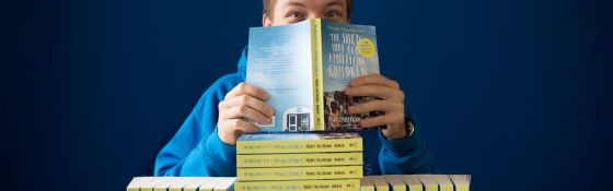 A supporter enjoys reading the Shed that Fed