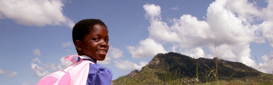 A young girl makes her way to school