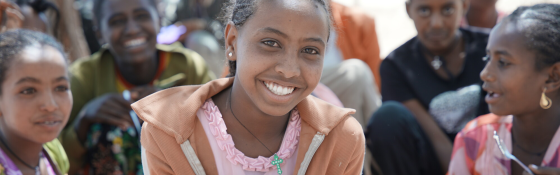 Picture of a girl smiling and looking at the camera