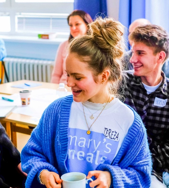 A volunteer in conversation at a Mary's Meals event