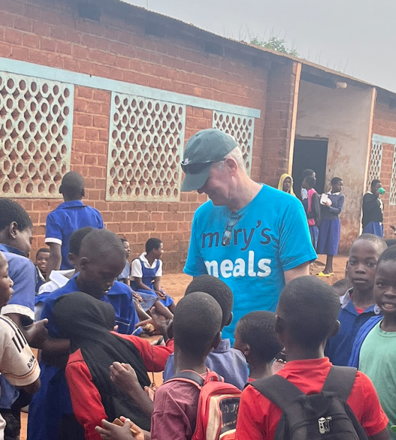 Arthur Coary meeting school children.