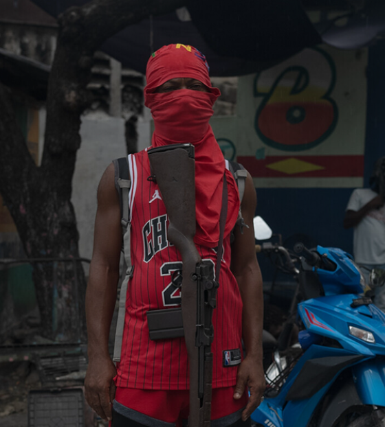 Child gang member posing with a gun
