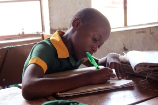 A boy takes notes in class in Zimbabwe