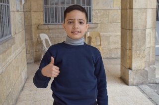 young boy smiling to the camera