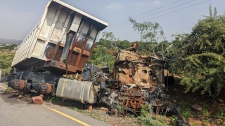 Image of a truck left destroyed and ruined by the roadside.