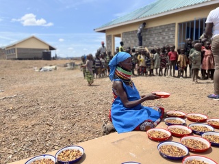 children waiting for Mary's Meals in Kenya