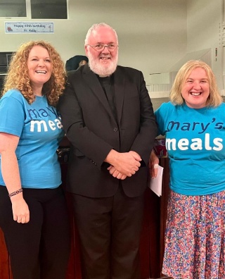 priest with volunteers